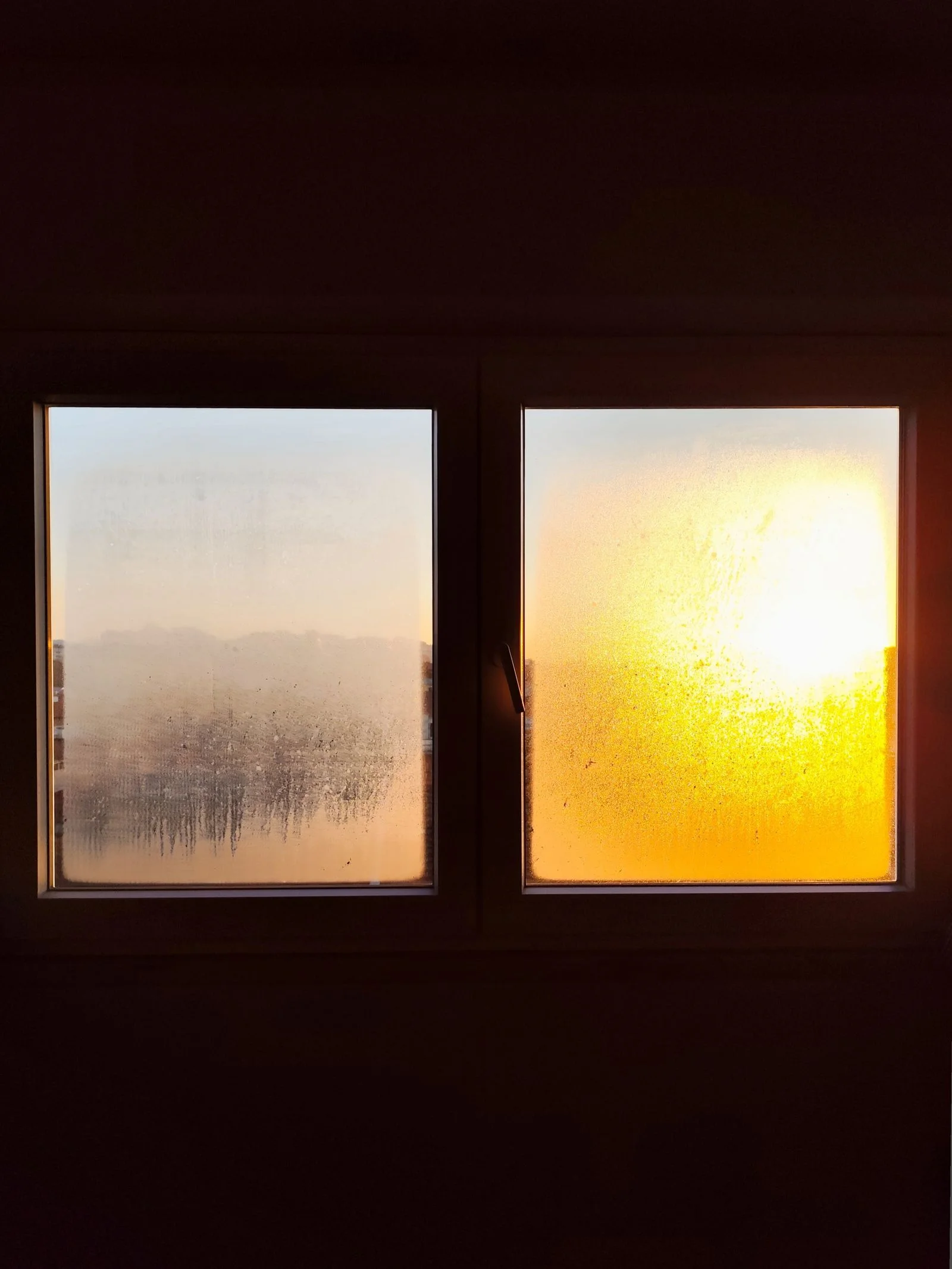 Warm morning sunlight glowing through a frosted window pane